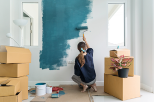 a homeowner painting one of their walls