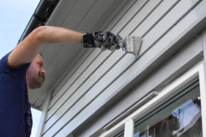 a homeowner repainting his home’s exterior